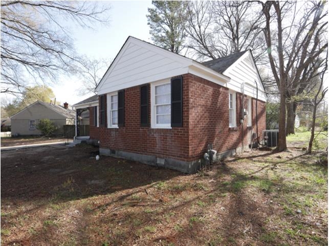 1180 Russwood Road Memphis, TN 38122 - Photo 4 of 5 Brick exterior with white siding accents and black window shutters