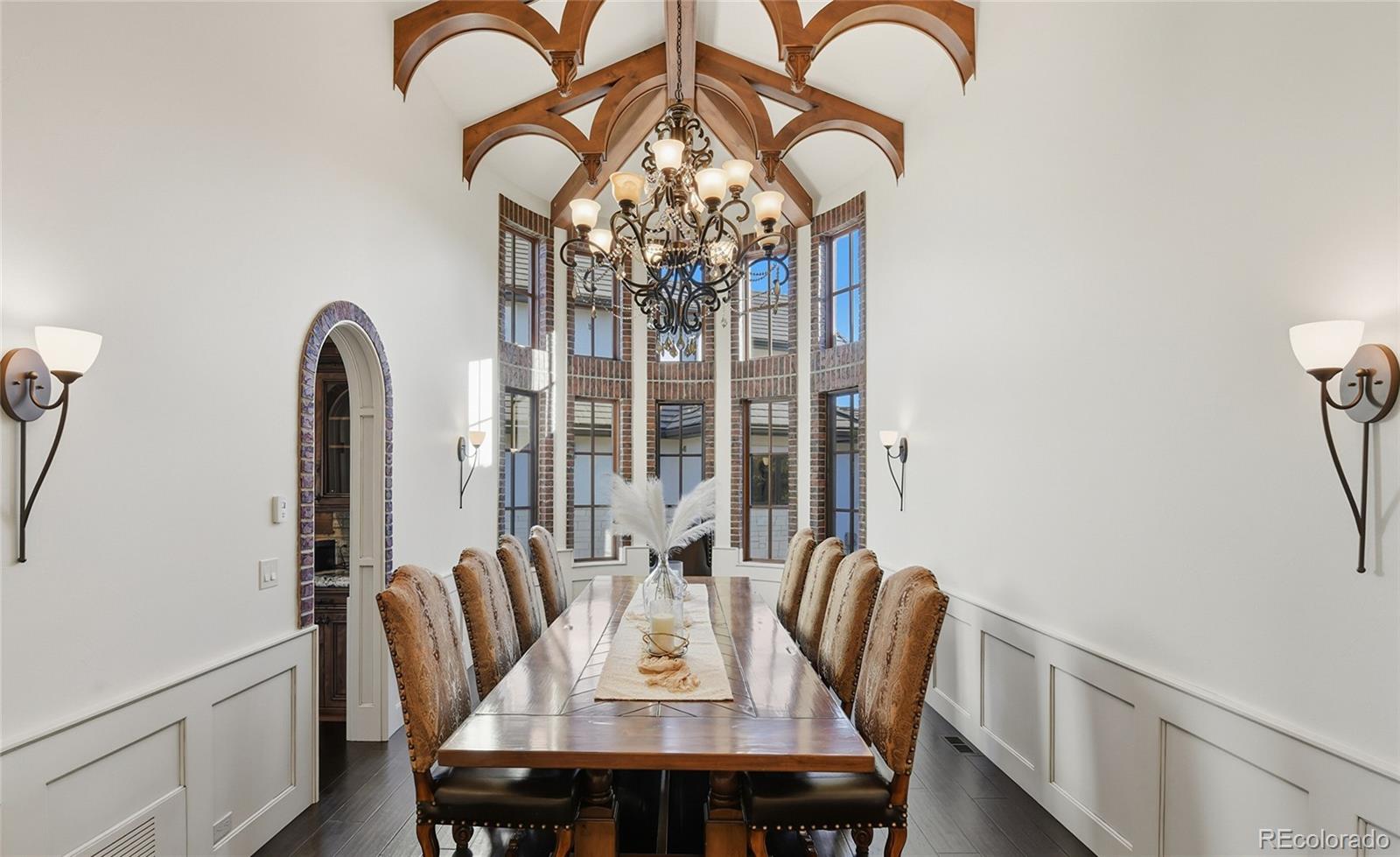 7188 Raphael Lane Littleton, CO 80125 - Photo 12 of 46 a view of a dining room with furniture window and wooden floor
