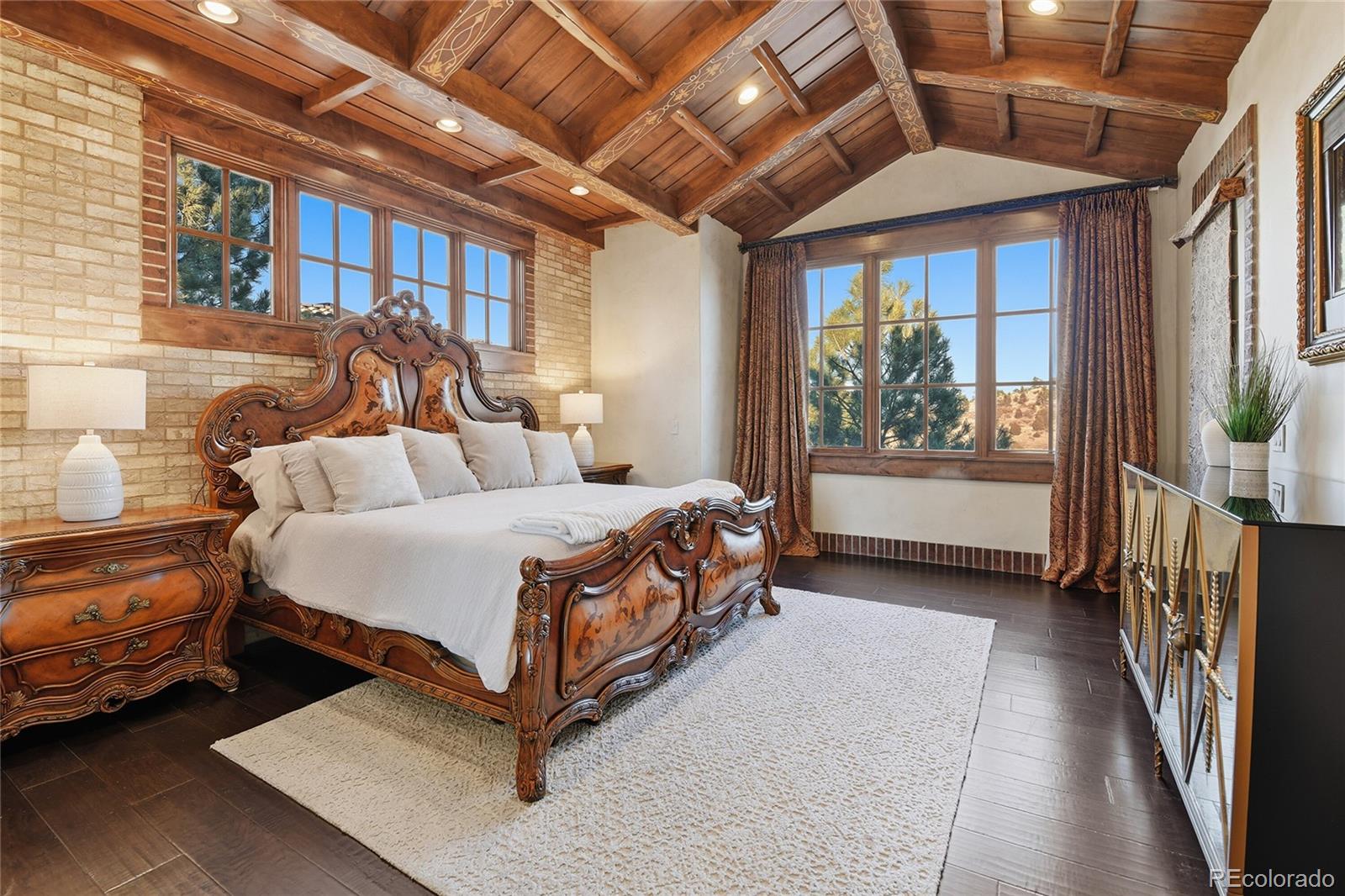 7188 Raphael Lane Littleton, CO 80125 - Photo 14 of 46 a spacious bedroom with a bed and a window