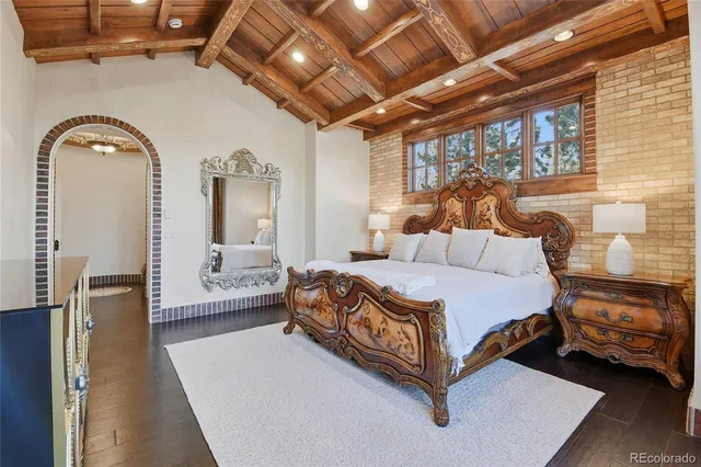 a spacious bedroom with a bed a couch and a table