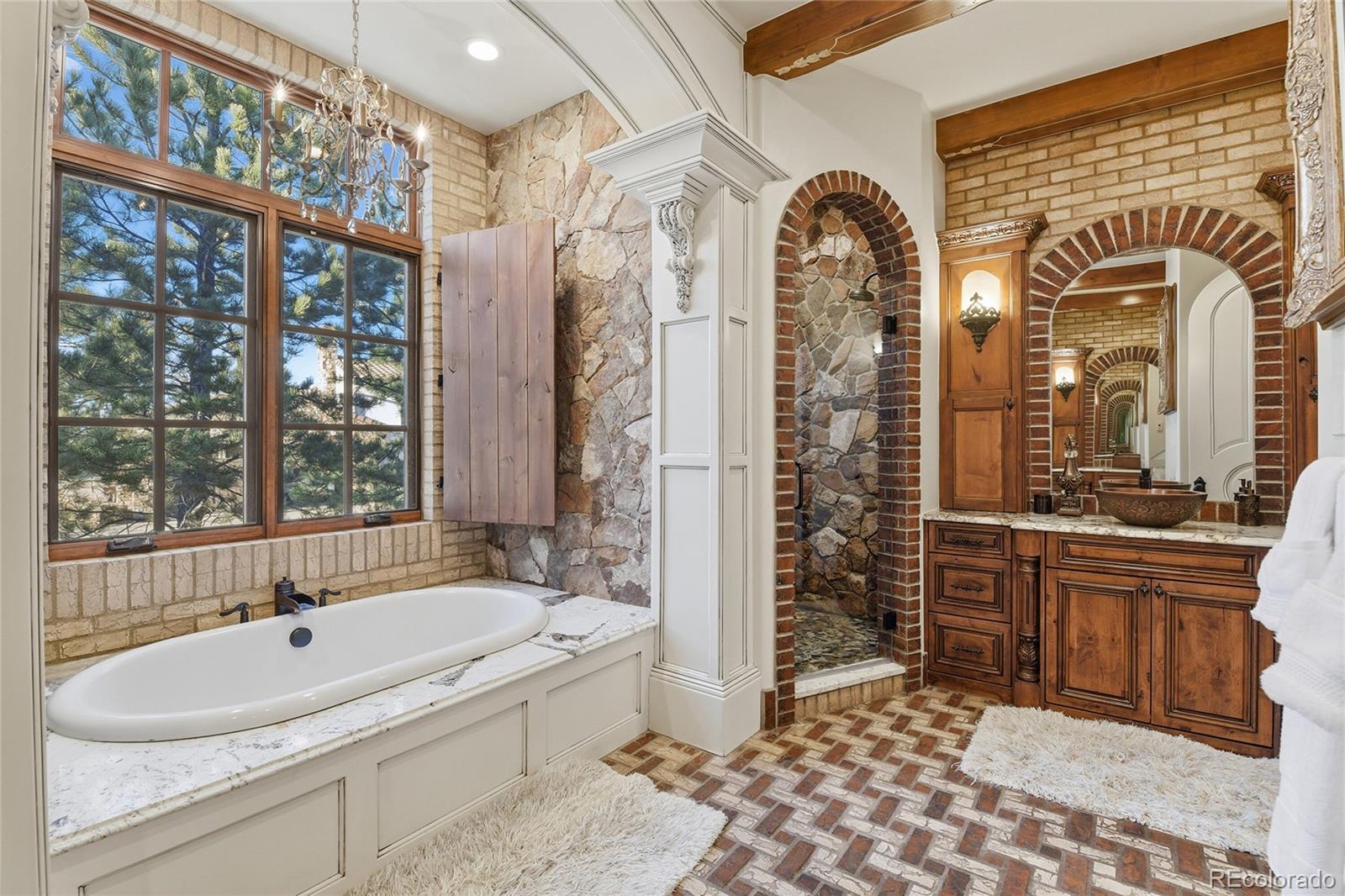 7188 Raphael Lane Littleton, CO 80125 - Photo 16 of 46 a bathroom with a bathtub a sink and a shower