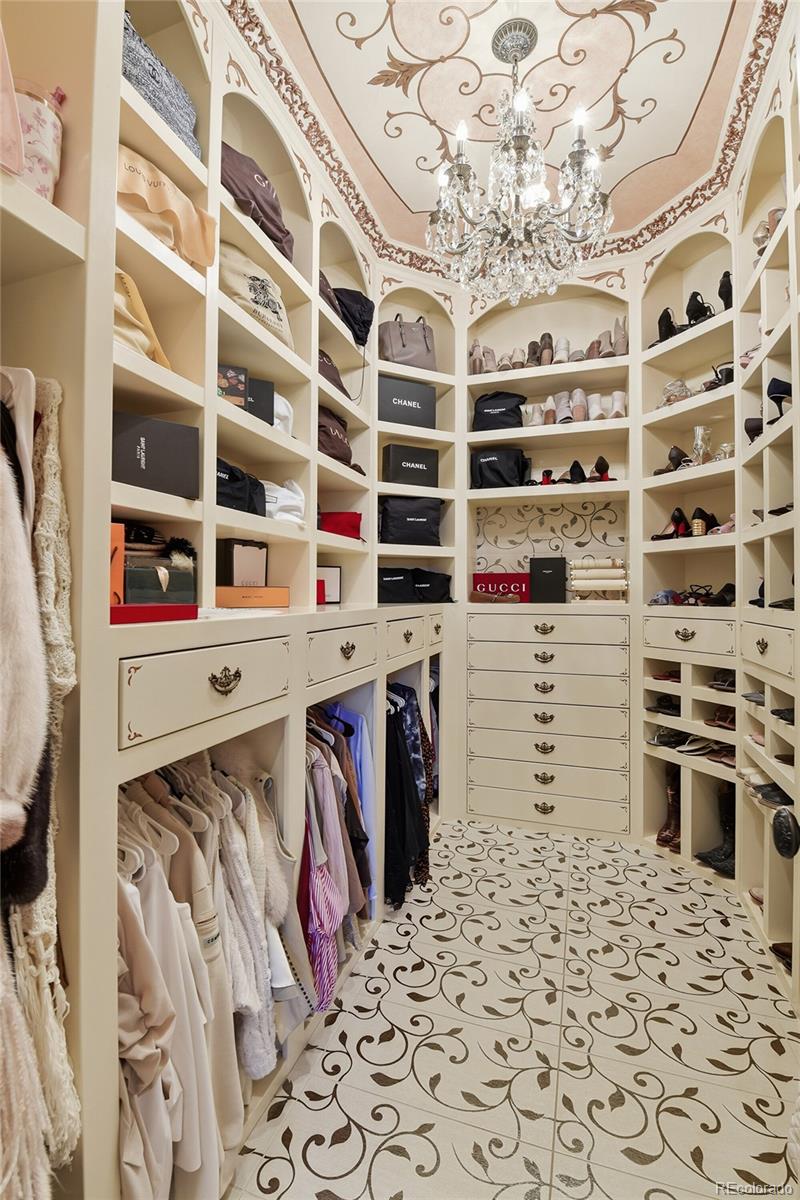 7188 Raphael Lane Littleton, CO 80125 - Photo 19 of 46 a view of walk in closet with clothes and shoes