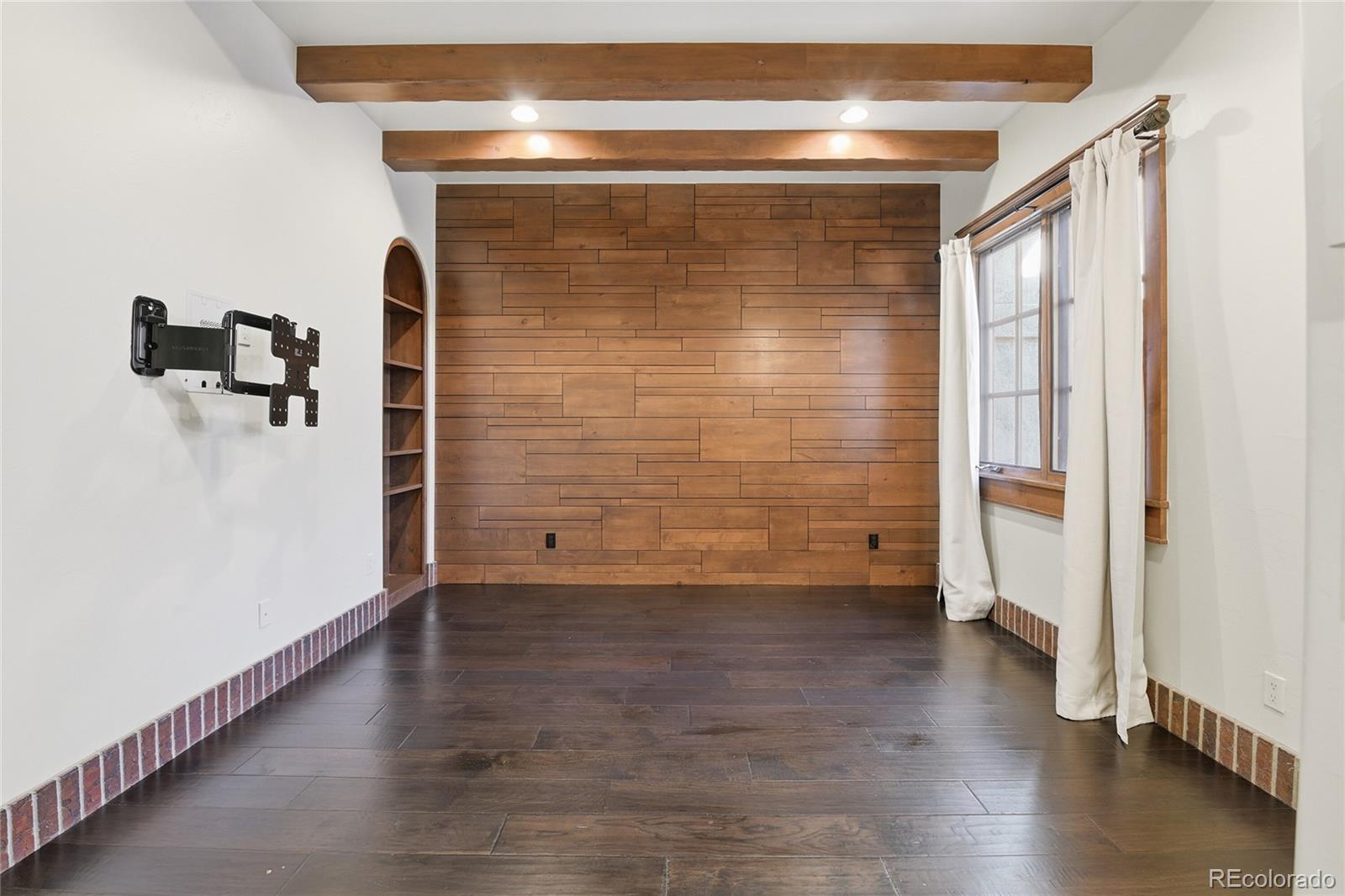 7188 Raphael Lane Littleton, CO 80125 - Photo 23 of 46 a view of empty room with wooden floor