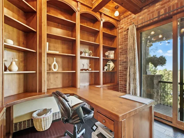 a room with pool table and glass windows