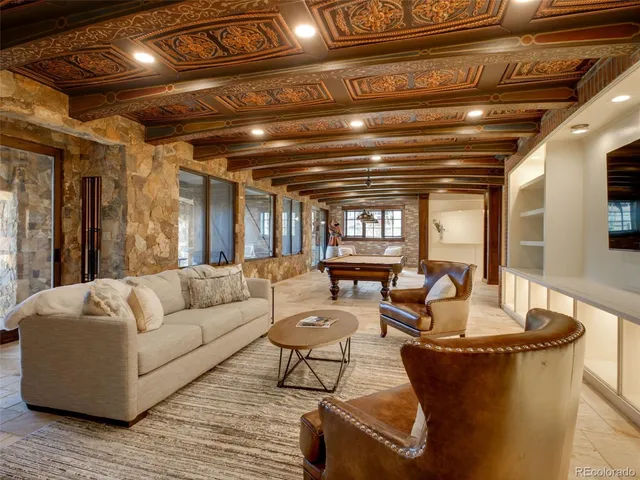 a living room with furniture and a chandelier