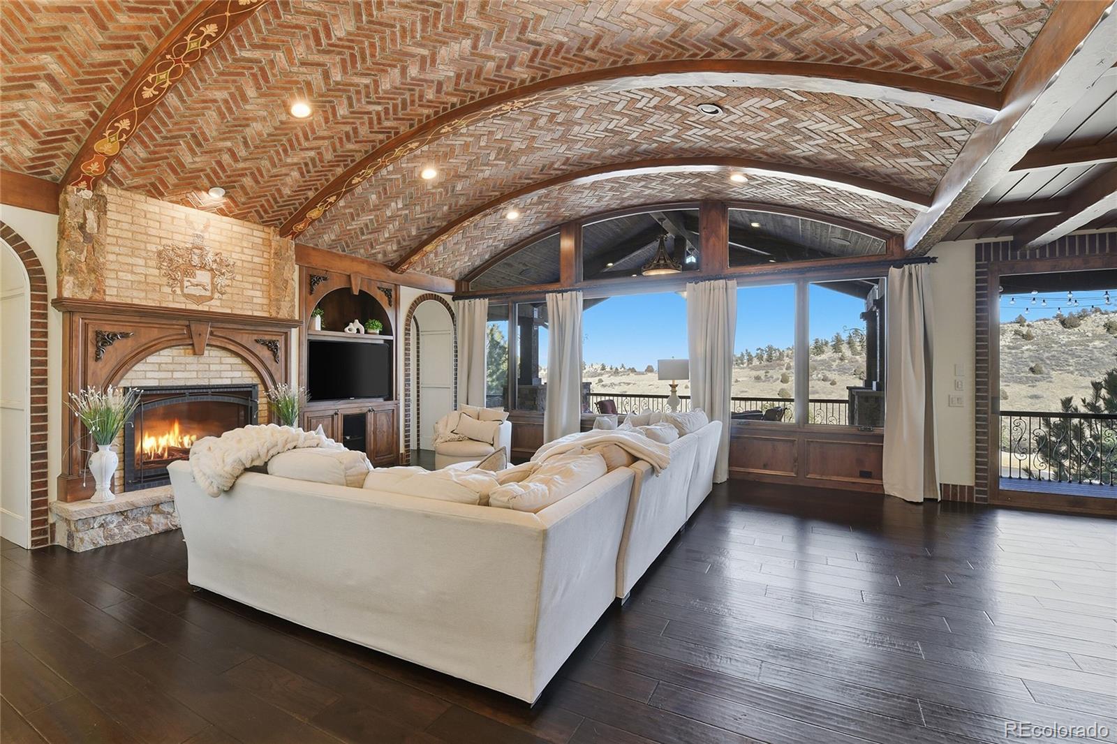 7188 Raphael Lane Littleton, CO 80125 - Photo 5 of 46 a living room with furniture and a fireplace