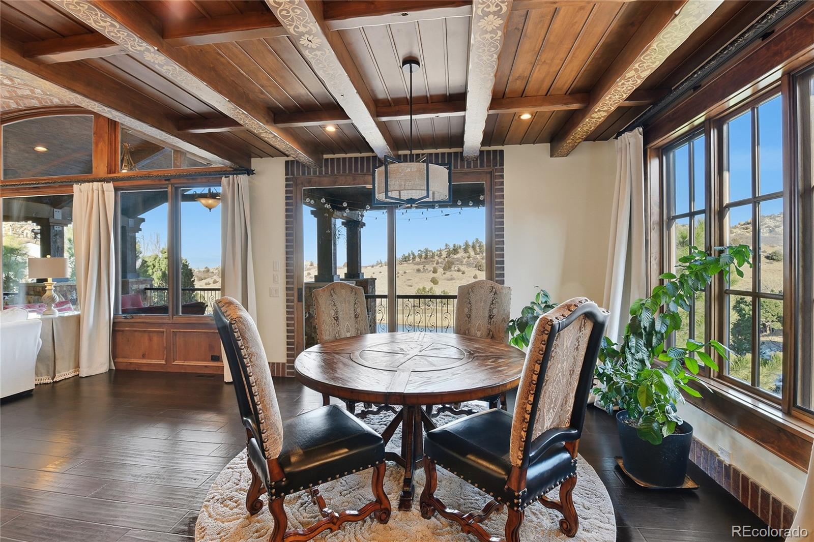 7188 Raphael Lane Littleton, CO 80125 - Photo 10 of 46 a view of a dining room with furniture window and wooden floor