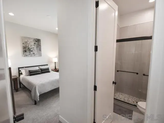 a bathroom with a tub and a glass door shower