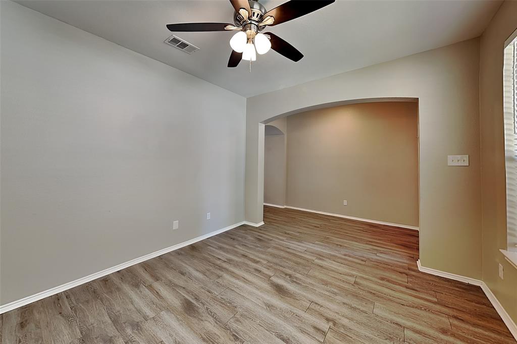 7016 Raintree Way Denton, TX 76210 - Photo 5 of 18 a view of an empty room with wooden floor