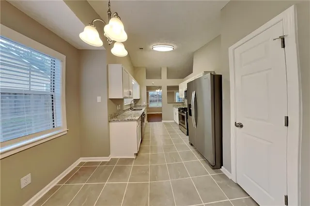 a view of a kitchen with a sink and a window