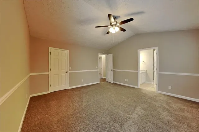 a view of an empty room with wooden floor and closet