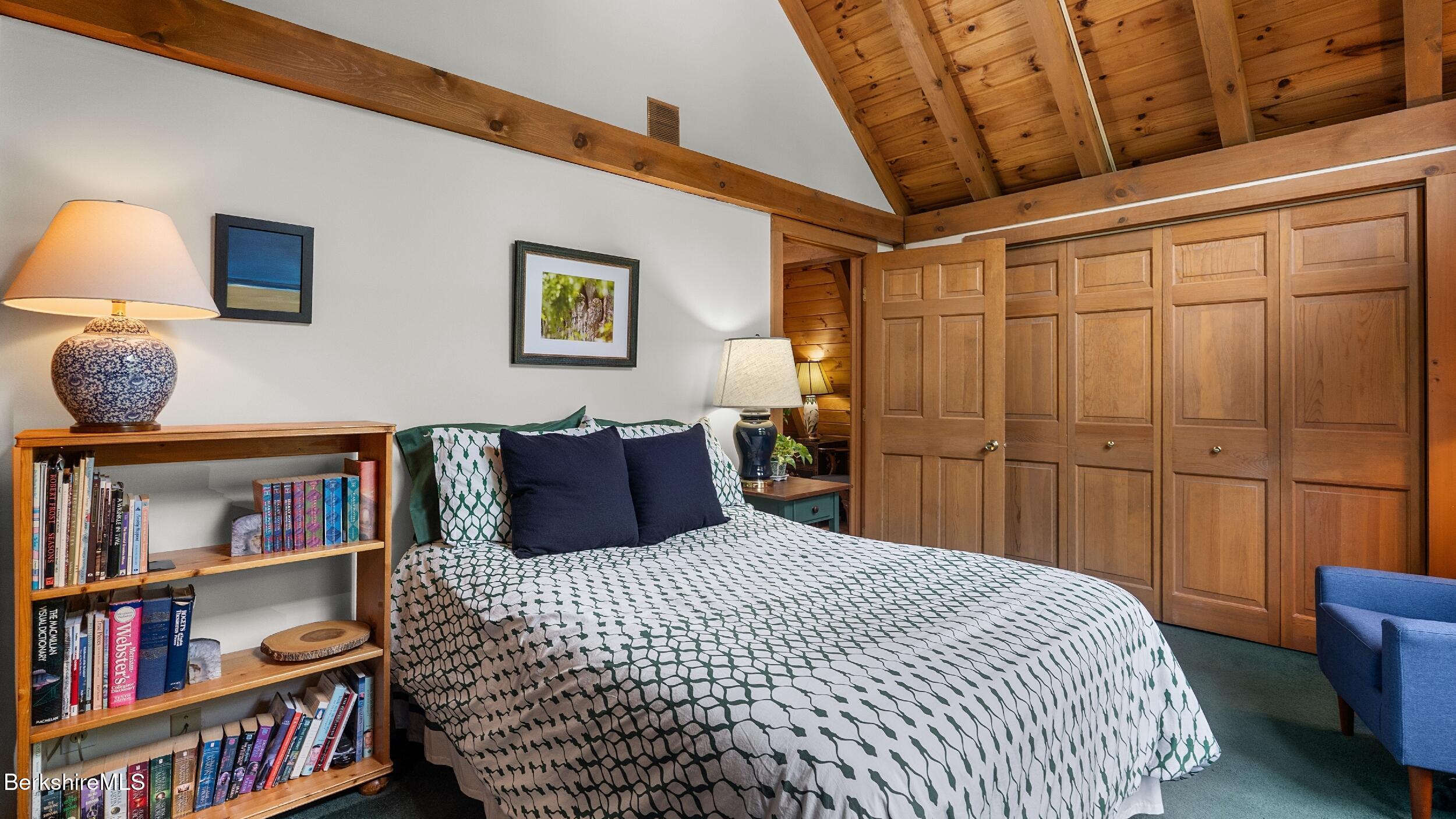 51 New Lenox Road Lenox, MA 01240 - Photo 19 of 38 a bedroom with a bed and a book shelf