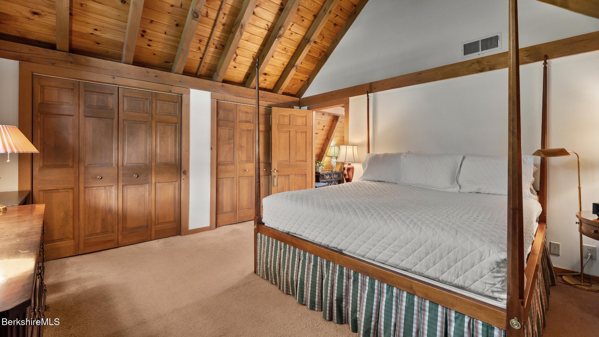 51 New Lenox Road Lenox, MA 01240 - Photo 23 of 38 a bedroom with a large bed and a chandelier