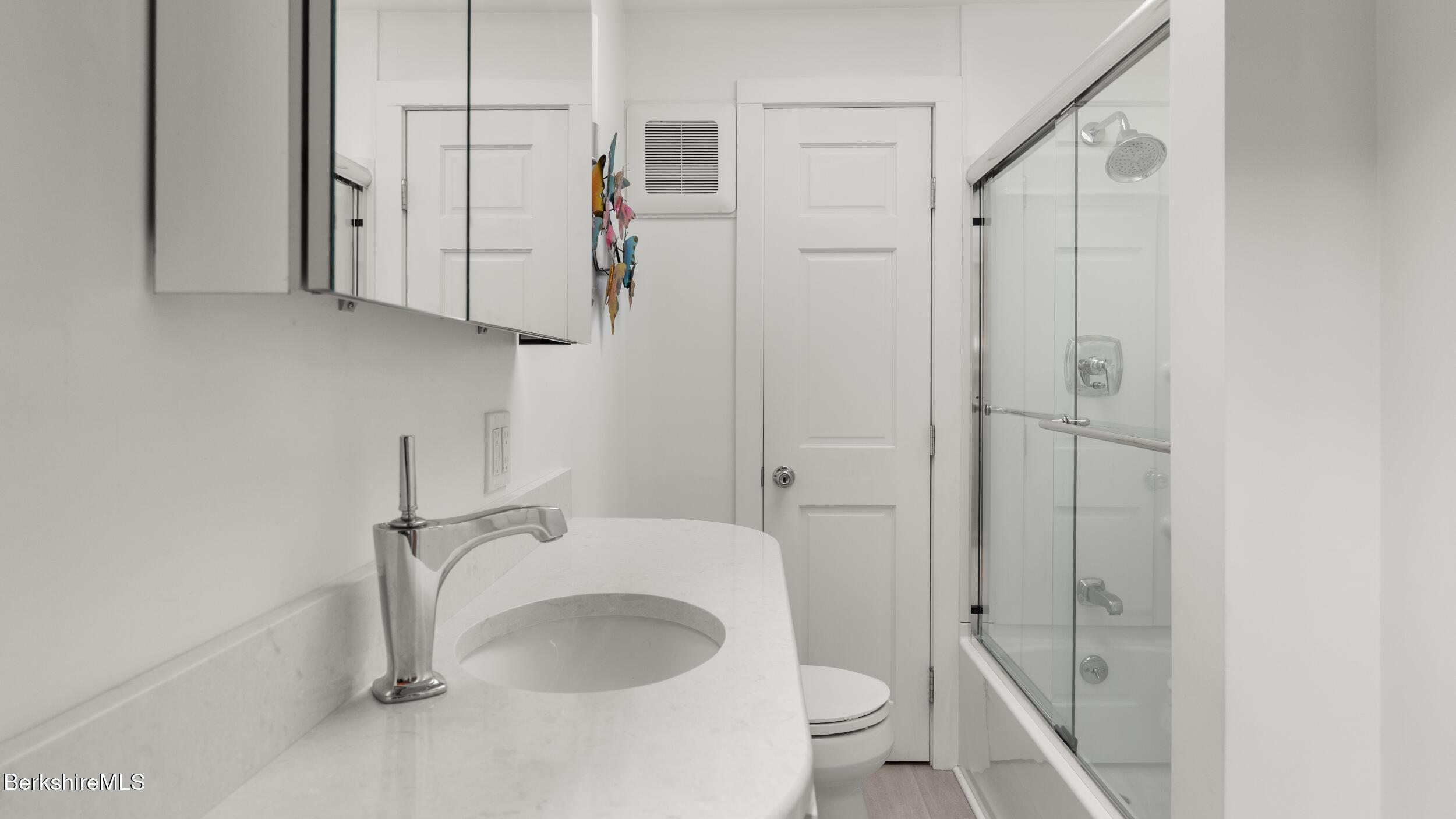 51 New Lenox Road Lenox, MA 01240 - Photo 27 of 38 a bathroom with a granite countertop sink toilet and shower
