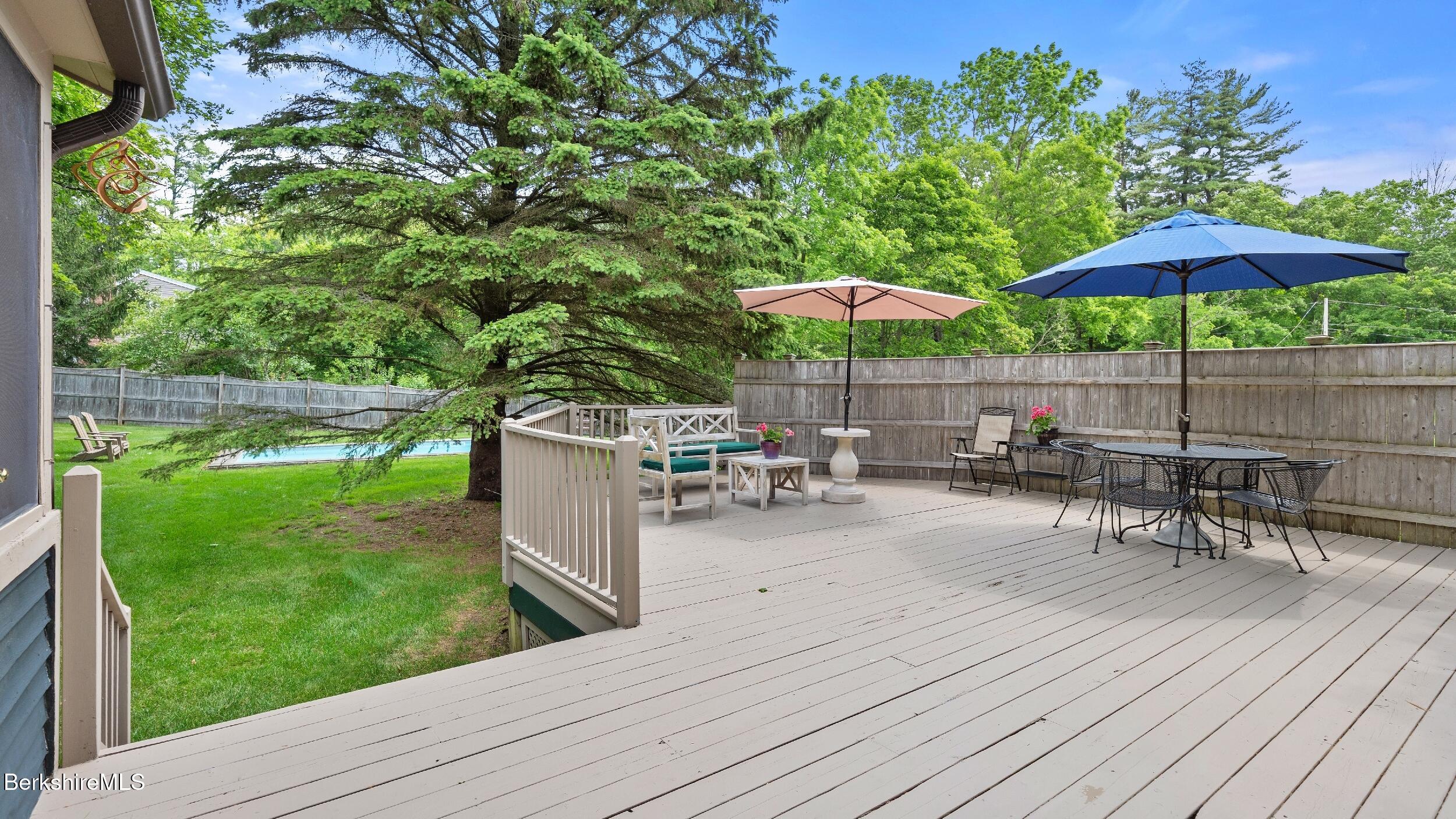51 New Lenox Road Lenox, MA 01240 - Photo 30 of 38 a view of a table and chairs under an umbrella