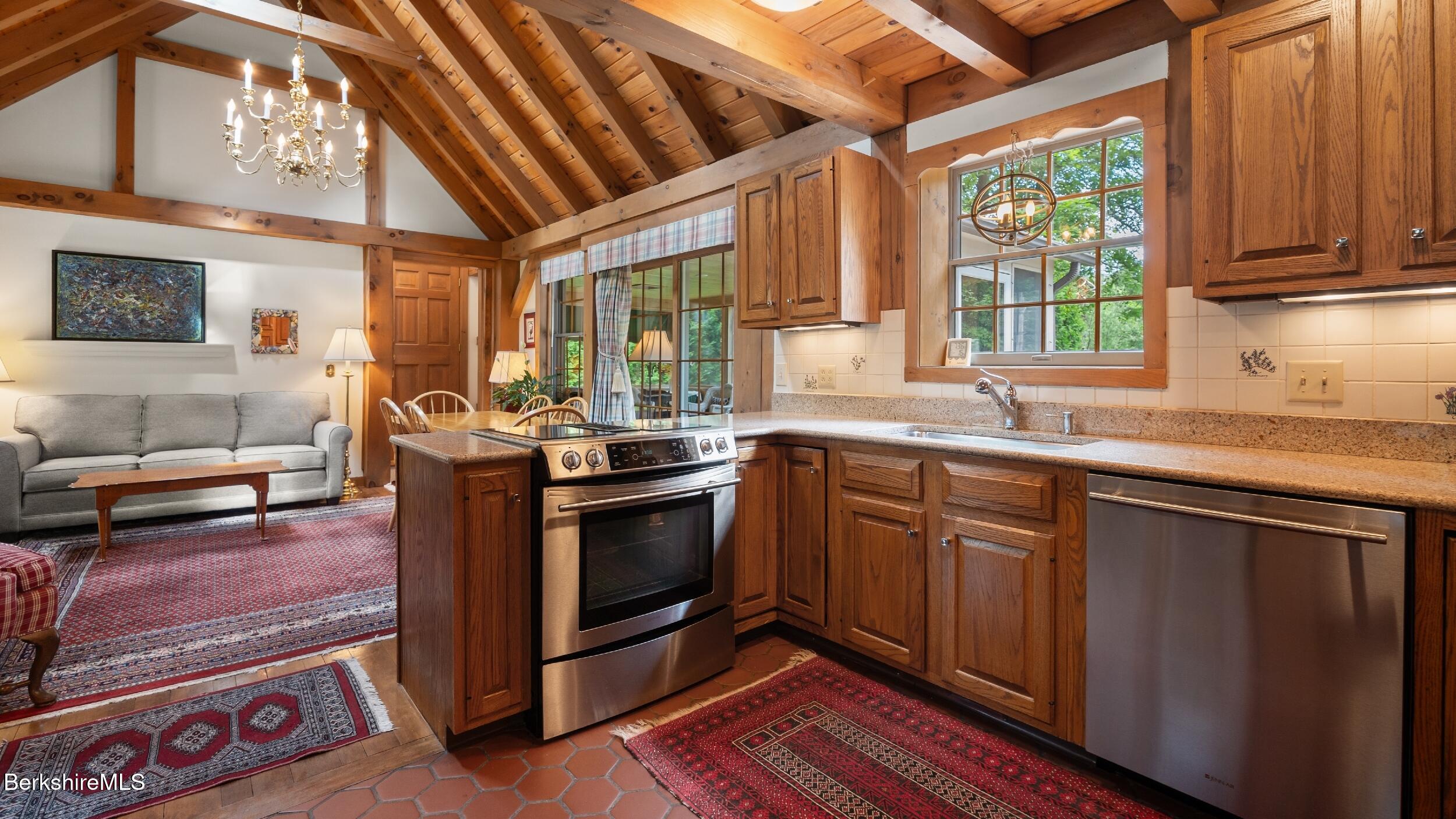 51 New Lenox Road Lenox, MA 01240 - Photo 7 of 38 a kitchen with stainless steel appliances granite countertop a sink stove and cabinets