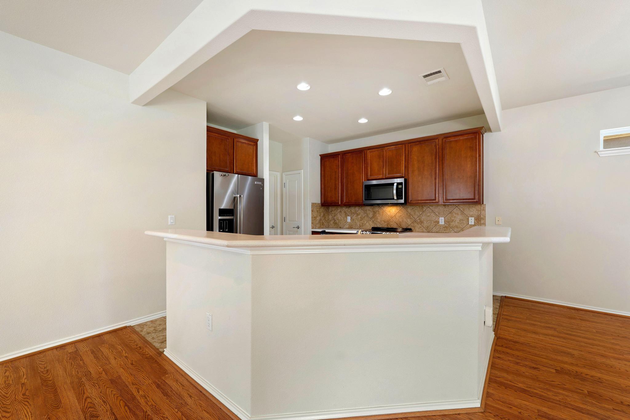 520 Mill Pond Path Georgetown, TX 78633 - Photo 15 of 38 A well-appointed kitchen features rich cabinetry, stainless steel appliances, and a convenient breakfast bar.