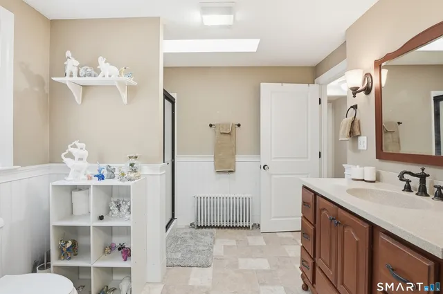 a bathroom with a sink vanity and a mirror