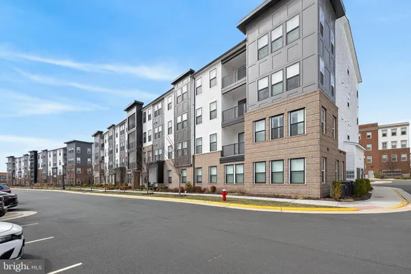 a view of a tall building next to a road