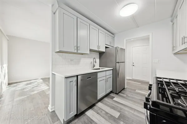 a kitchen with a sink stove and refrigerator