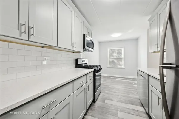 a kitchen with stainless steel appliances granite countertop a sink and a stove