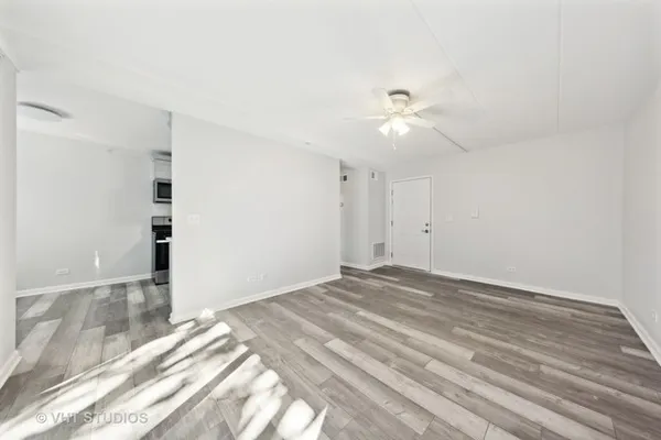 a view of empty room with ceiling fan