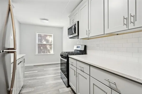a kitchen with stainless steel appliances granite countertop a sink and a stove