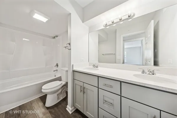 a bathroom with a sink a toilet and a large mirror