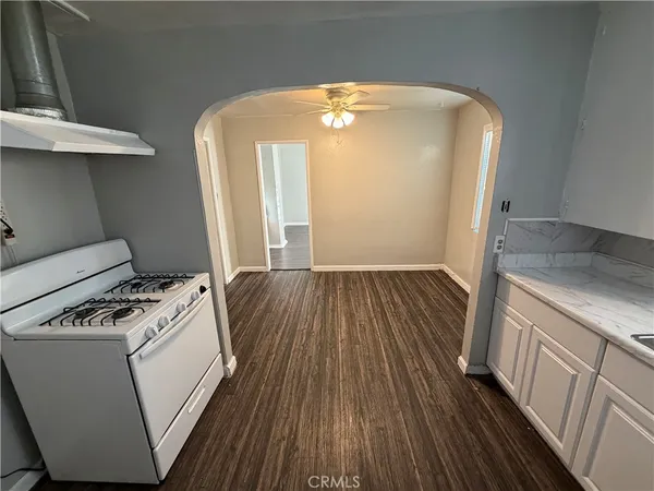 a hallway with washer and dryer with wooden floor