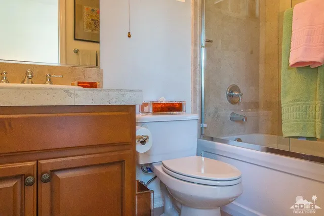 a view of a patio with table and chairs potted plants and palm trees