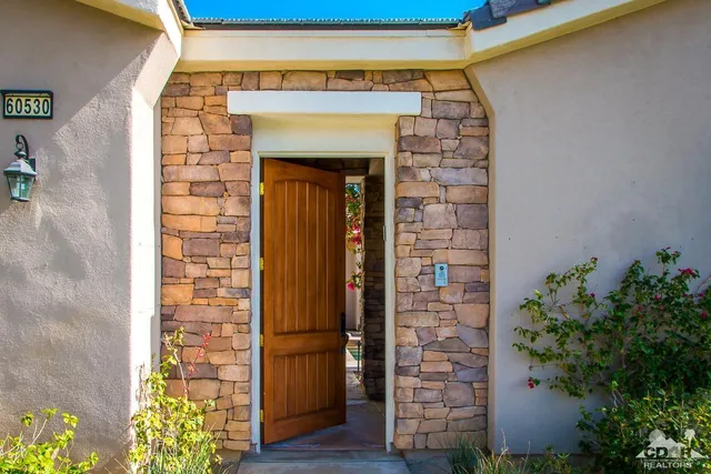 a kitchen with stainless steel appliances granite countertop a kitchen island a stove a sink dishwasher and white cabinets with wooden floor