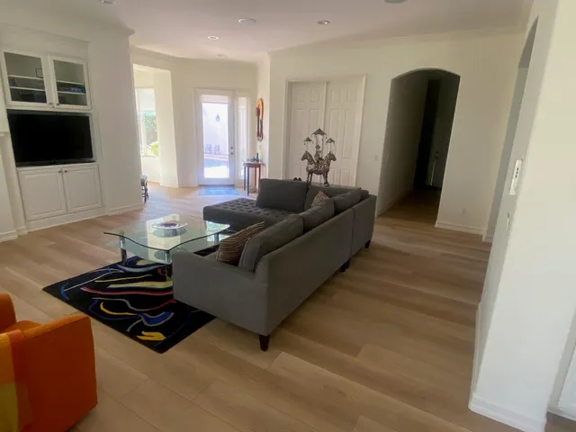a view of a dining room with furniture and a chandelier