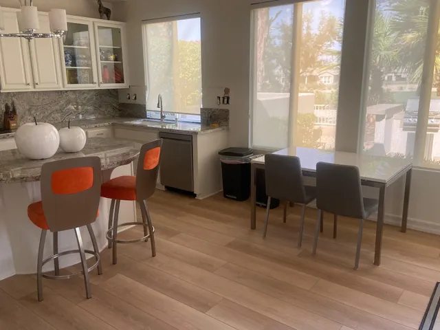 a living room with furniture and a floor to ceiling window