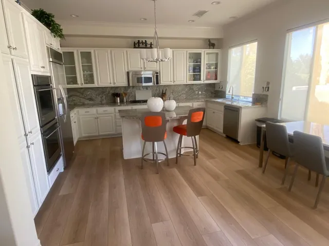a living room with furniture large window and a mirror
