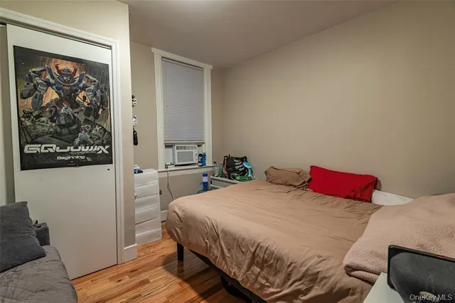 a bedroom with a bed and a painting on the wall