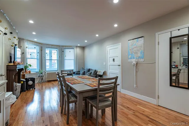 a view of a a dining room with furniture window and wooden floor
