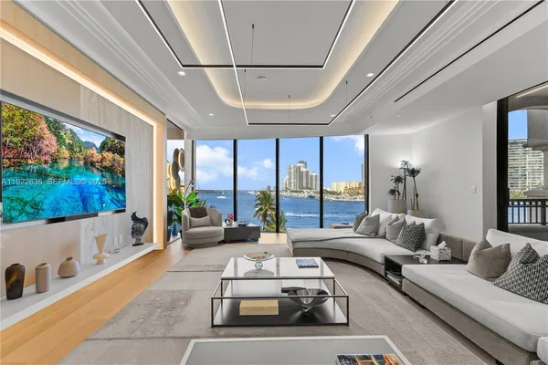 a living room with furniture and a floor to ceiling window