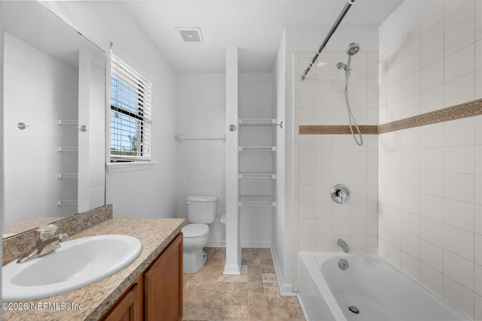 253 Syrah Way St. Augustine, FL 32084 - Photo 23 of 39 a bathroom with a granite countertop sink a toilet and shower