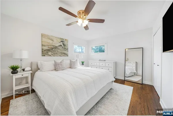 a bedroom with a large bed and a chandelier