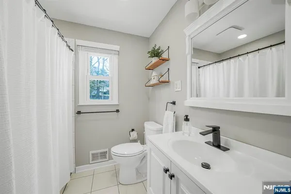 a bathroom with a sink toilet and vanity