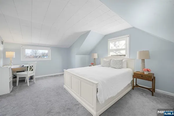 a bedroom with a bed and a chair