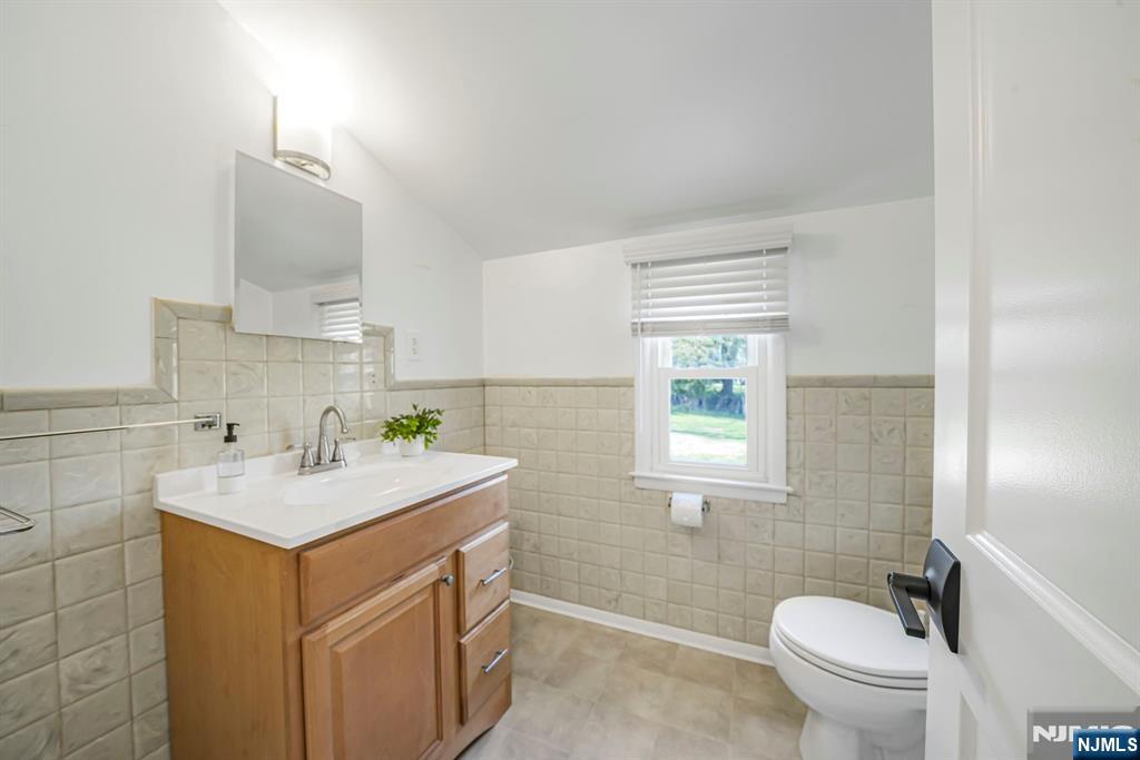 21 Joseph Place Wayne, NJ 07470 - Photo 18 of 32 a bathroom with a sink toilet vanity and window