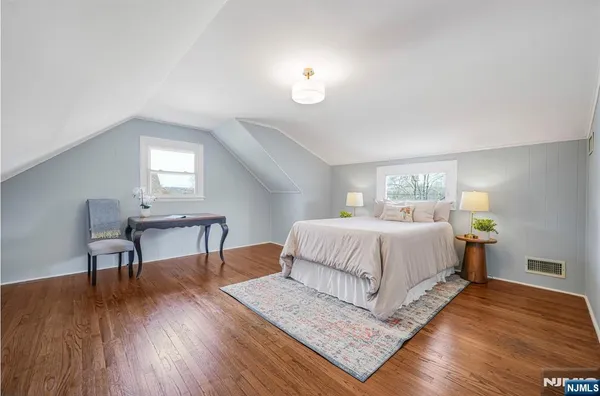 a bedroom with a bed a table and chair