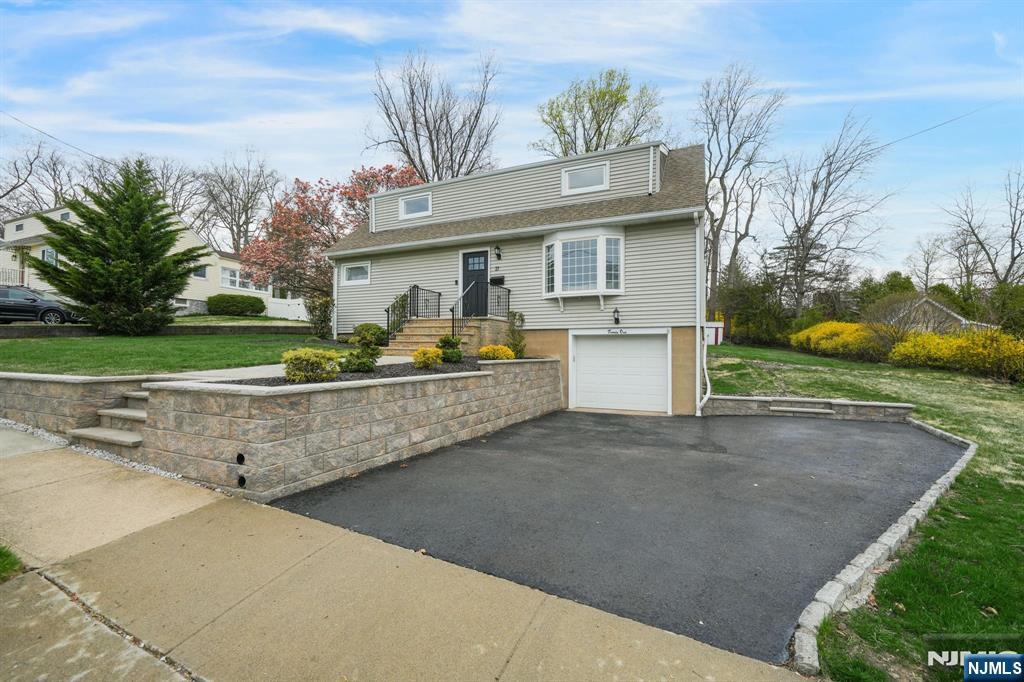 21 Joseph Place Wayne, NJ 07470 - Photo 2 of 32 a front view of a house with a yard and garage