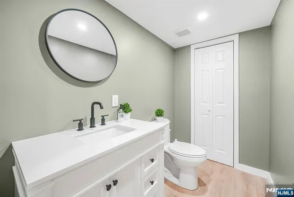 a bathroom with a sink a mirror and a toilet
