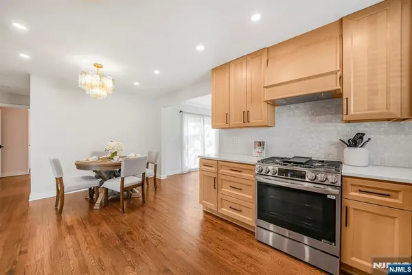 a kitchen with a stove a sink and a refrigerator