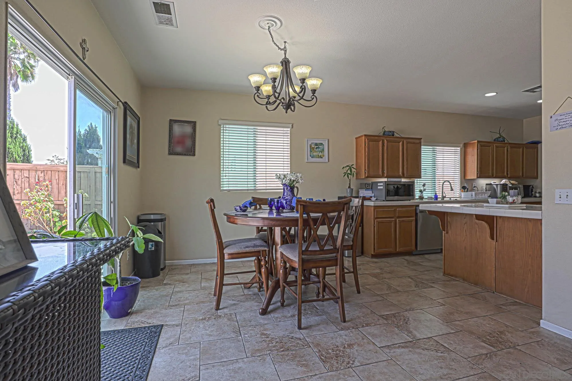 914 Rigley Street Chula Vista, CA 91911 - Photo 13 of 35 a kitchen with a dining table chairs and microwave