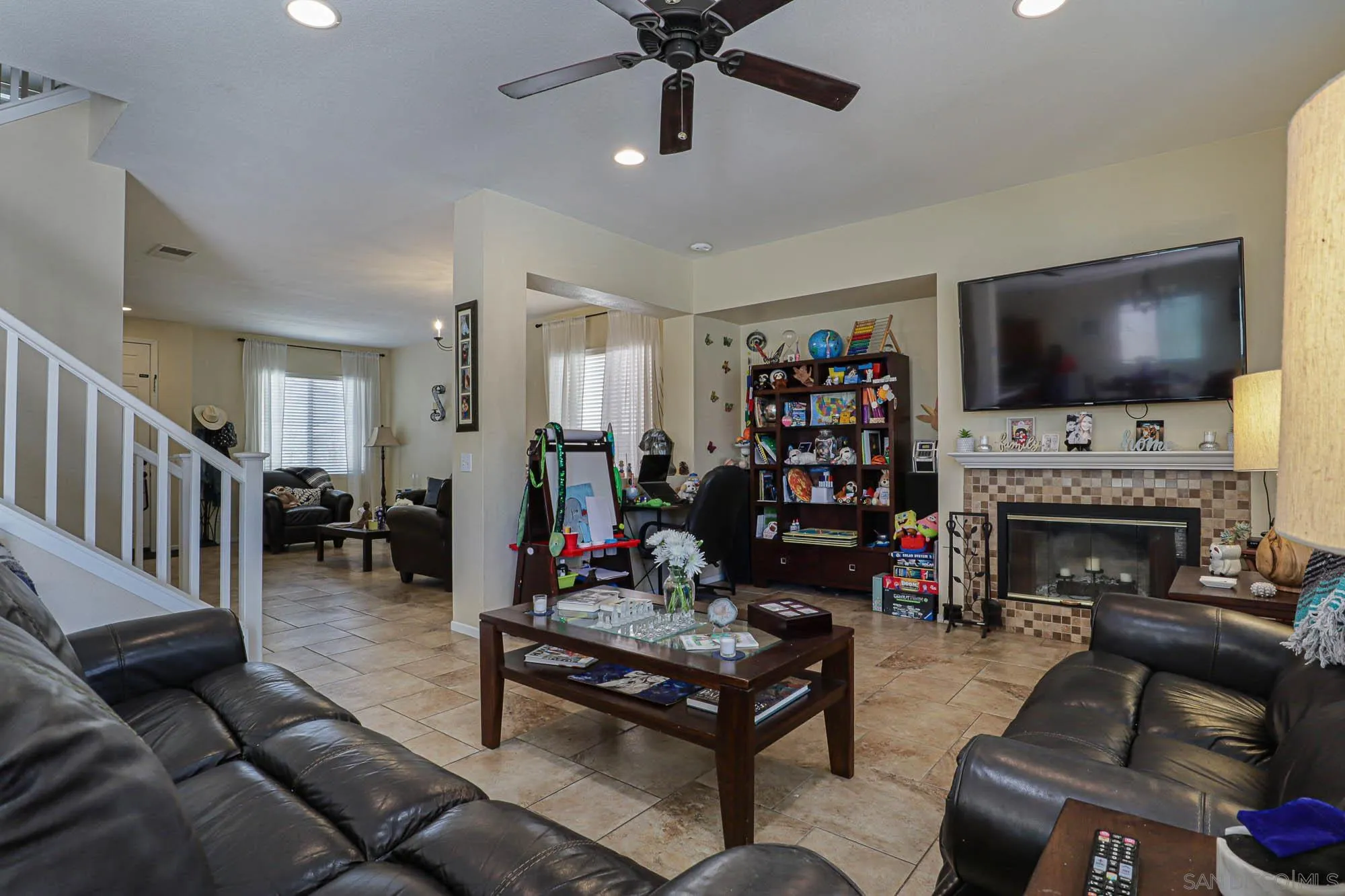 914 Rigley Street Chula Vista, CA 91911 - Photo 14 of 35 a living room with furniture a flat screen tv and a fireplace