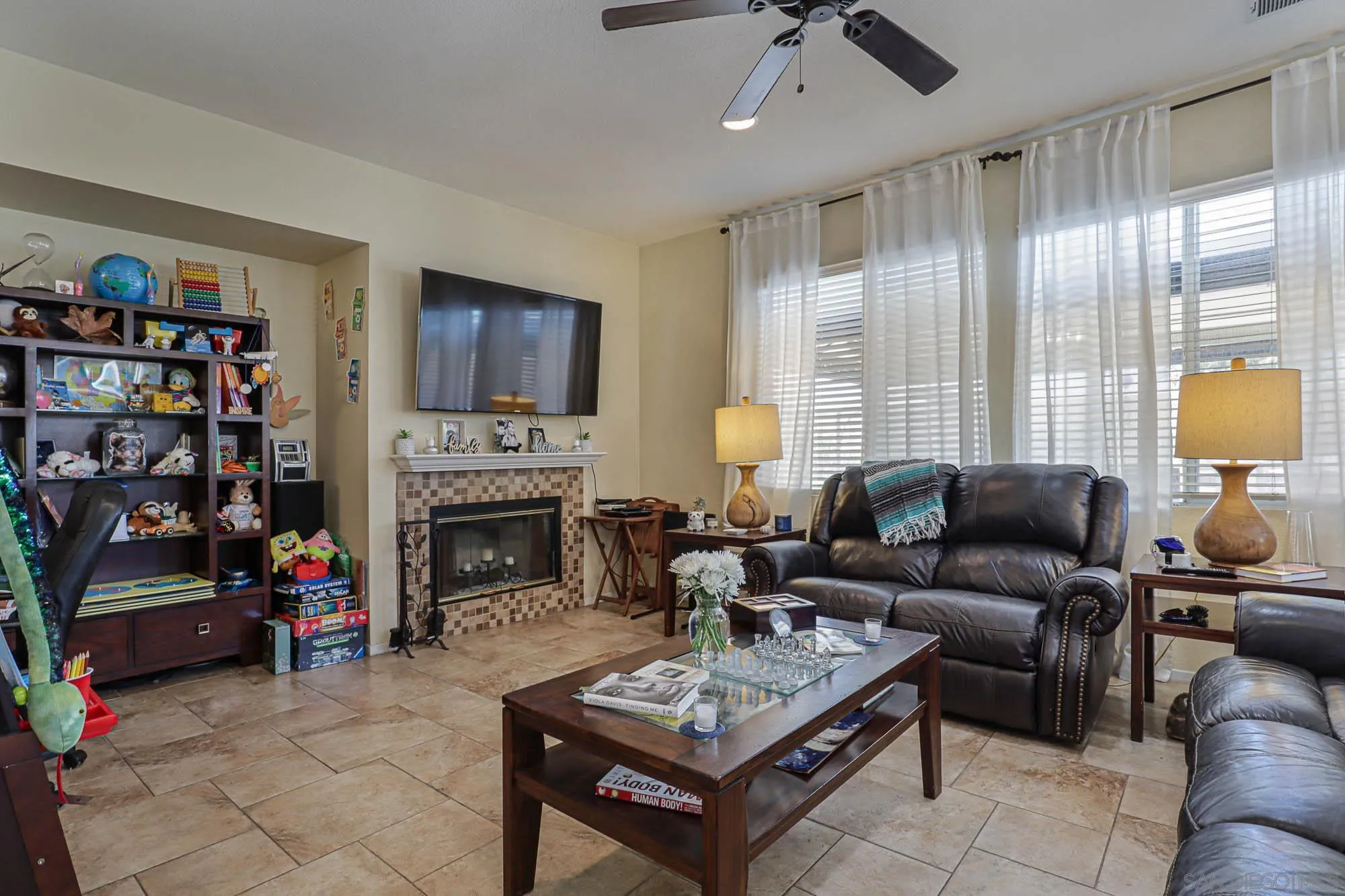 914 Rigley Street Chula Vista, CA 91911 - Photo 15 of 35 a living room with furniture a fireplace and a window