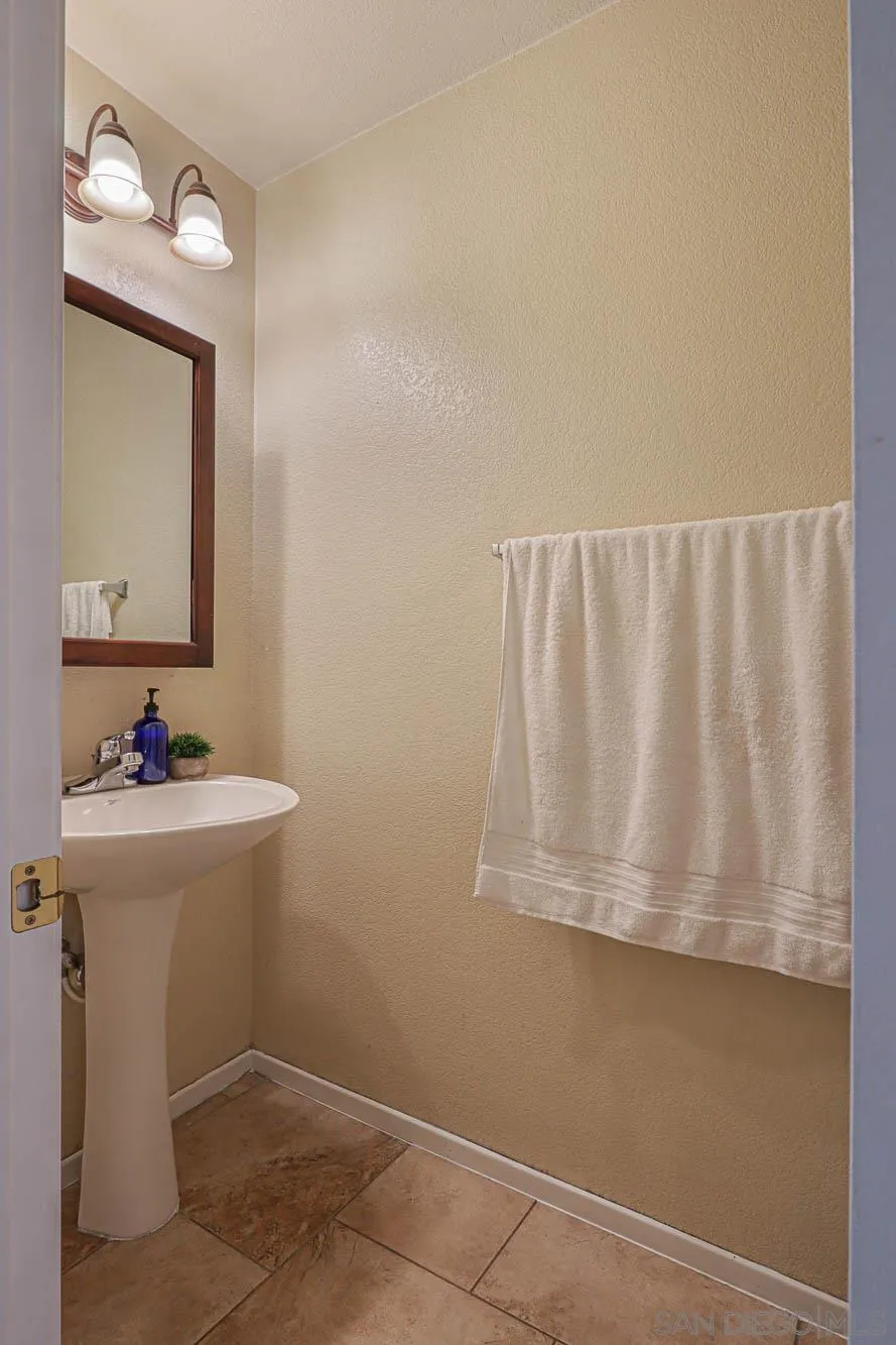 914 Rigley Street Chula Vista, CA 91911 - Photo 17 of 35 a bathroom with a sink a mirror and a toilet